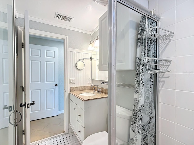 bathroom with ornamental molding, vanity, tile patterned flooring, and toilet