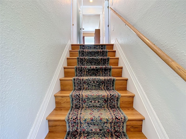 stairway featuring wood-type flooring