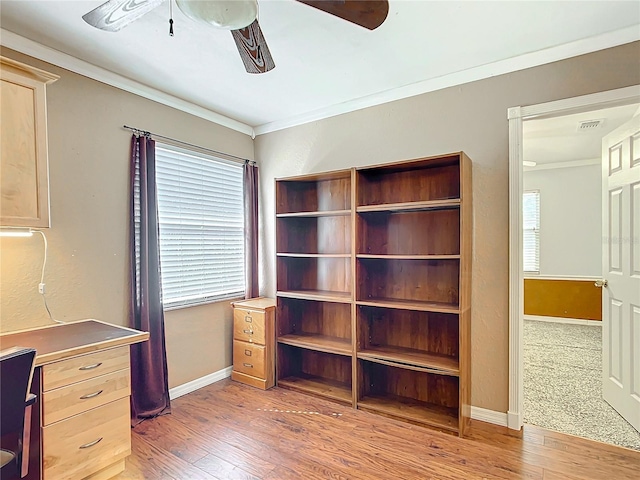 unfurnished office with ceiling fan, hardwood / wood-style flooring, and crown molding