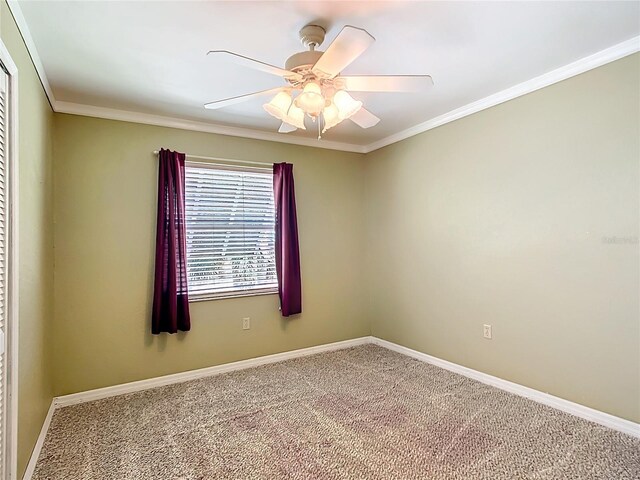 unfurnished room with carpet floors, crown molding, and ceiling fan