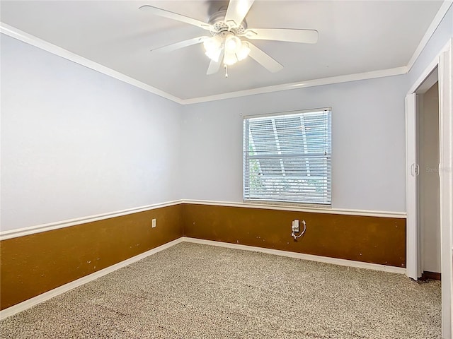 carpeted spare room with crown molding and ceiling fan