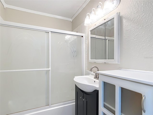 bathroom featuring combined bath / shower with glass door, vanity, and crown molding