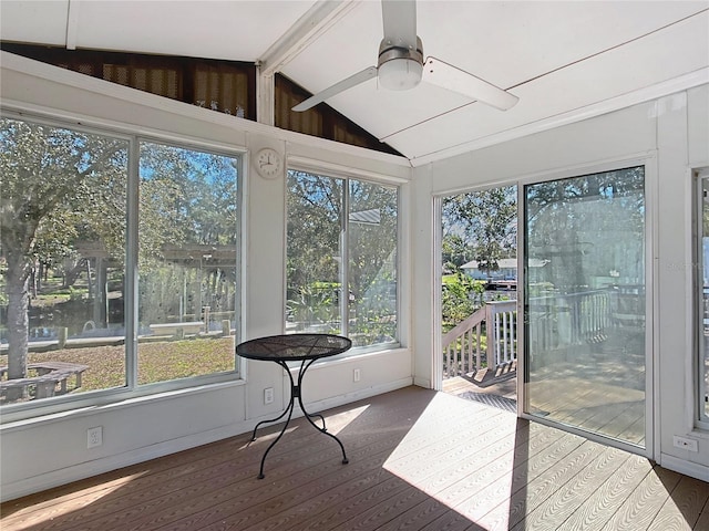 sunroom featuring vaulted ceiling with beams, ceiling fan, and a water view