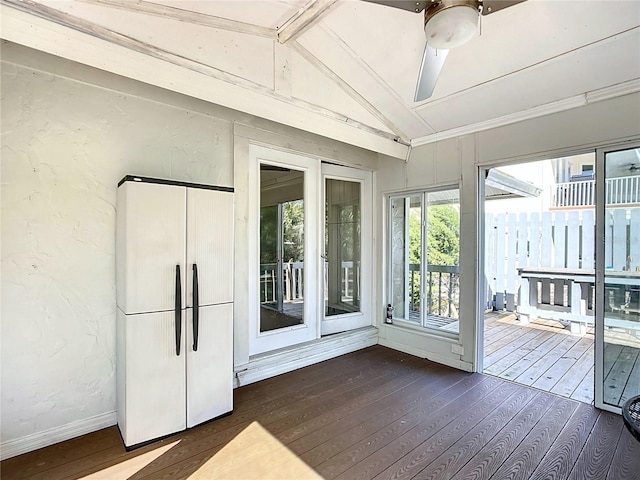 unfurnished sunroom featuring ceiling fan and lofted ceiling with beams