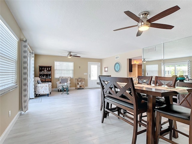 dining area featuring light hardwood / wood-style flooring and ceiling fan