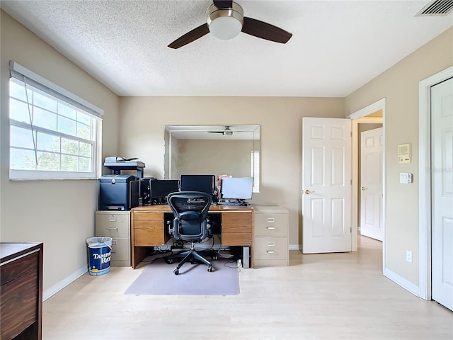 office space with ceiling fan, light hardwood / wood-style flooring, and a textured ceiling