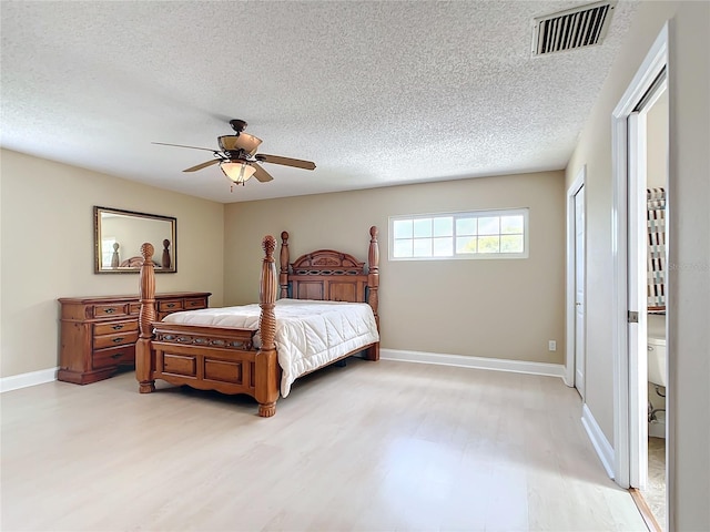 bedroom with a textured ceiling, light hardwood / wood-style floors, and ceiling fan