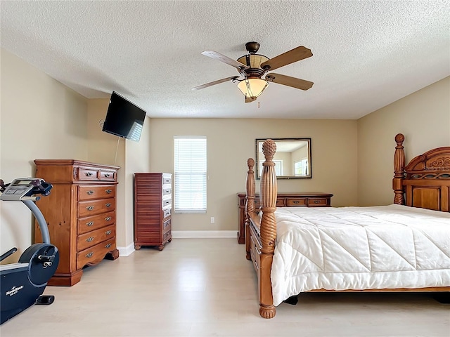 bedroom featuring a textured ceiling and ceiling fan