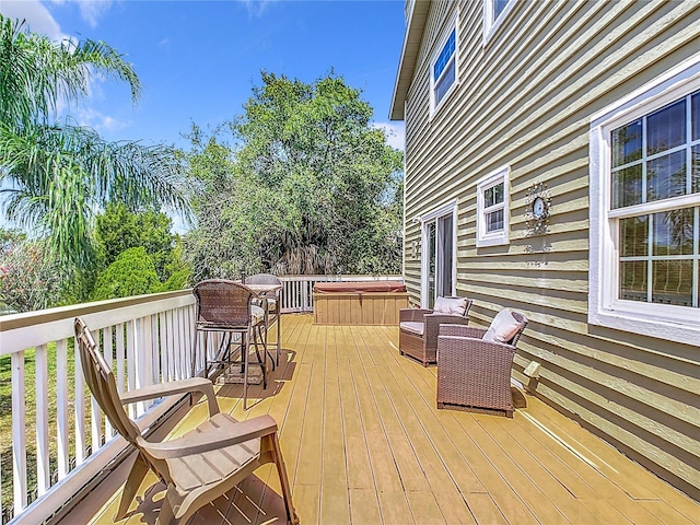 wooden deck with a hot tub