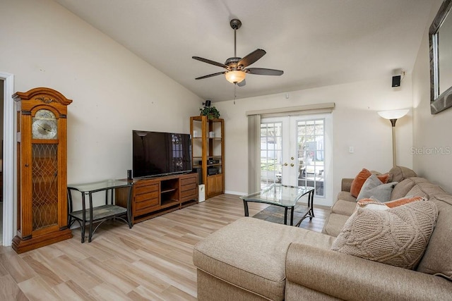 living room with ceiling fan, french doors, vaulted ceiling, and light wood-type flooring