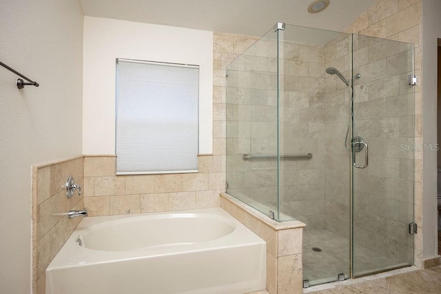 bathroom featuring shower with separate bathtub