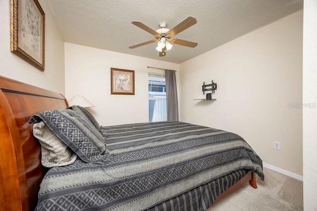 carpeted bedroom with a textured ceiling and ceiling fan