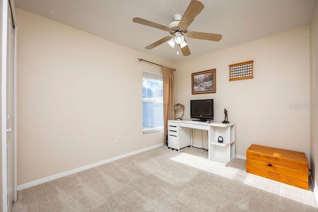 carpeted home office with ceiling fan