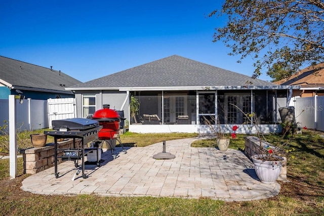 back of house with a patio area and a sunroom