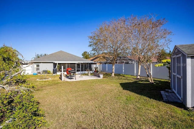 view of yard featuring a storage unit, a sunroom, and a patio area