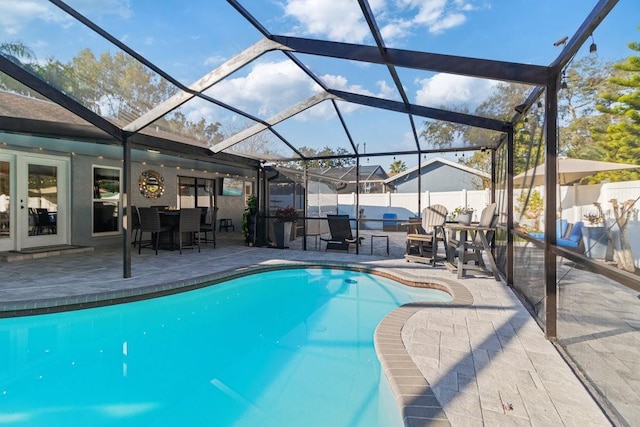 view of swimming pool featuring a lanai and a patio