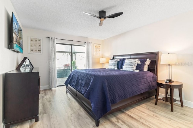 bedroom featuring ceiling fan, access to exterior, light wood-type flooring, and a textured ceiling