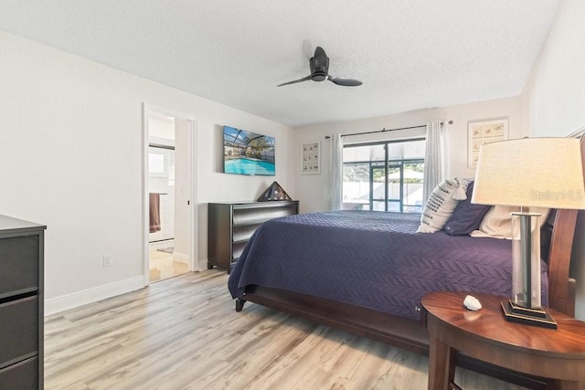 bedroom featuring connected bathroom, access to exterior, ceiling fan, a textured ceiling, and light wood-type flooring