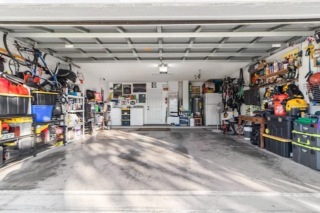 garage with white fridge and water heater