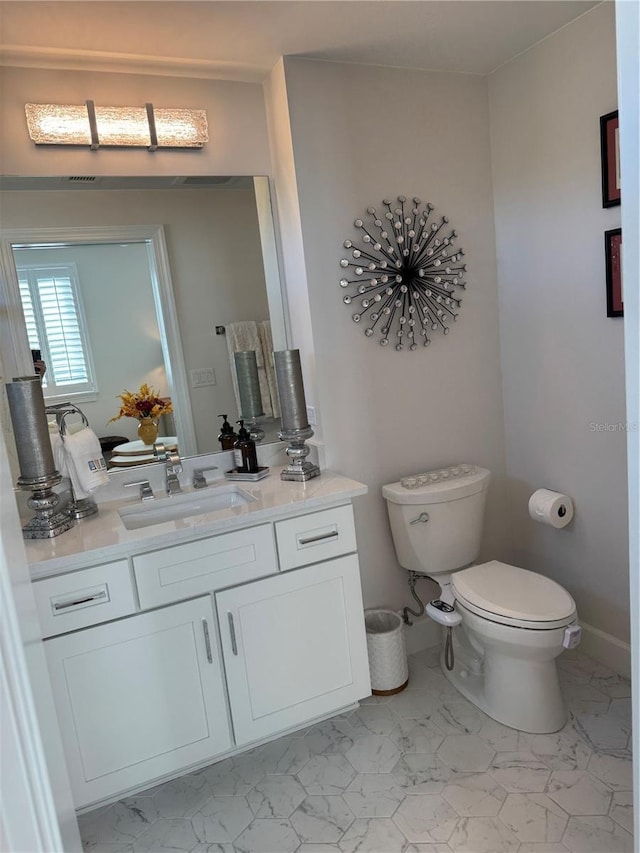 bathroom with vanity and toilet