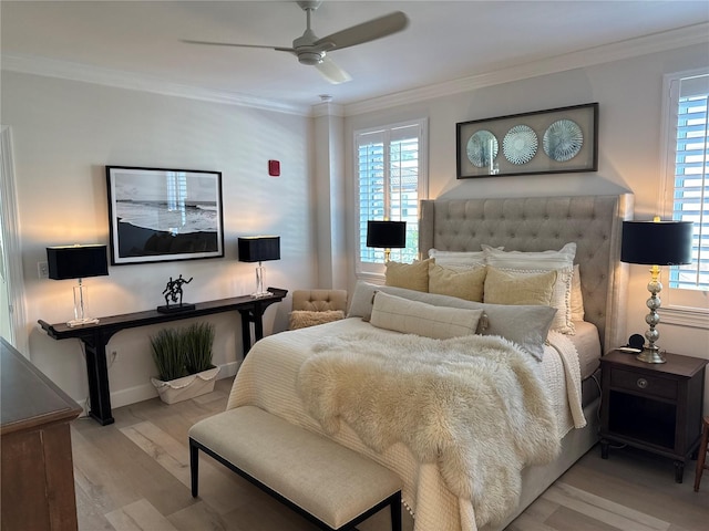 bedroom featuring multiple windows, ornamental molding, and light hardwood / wood-style floors