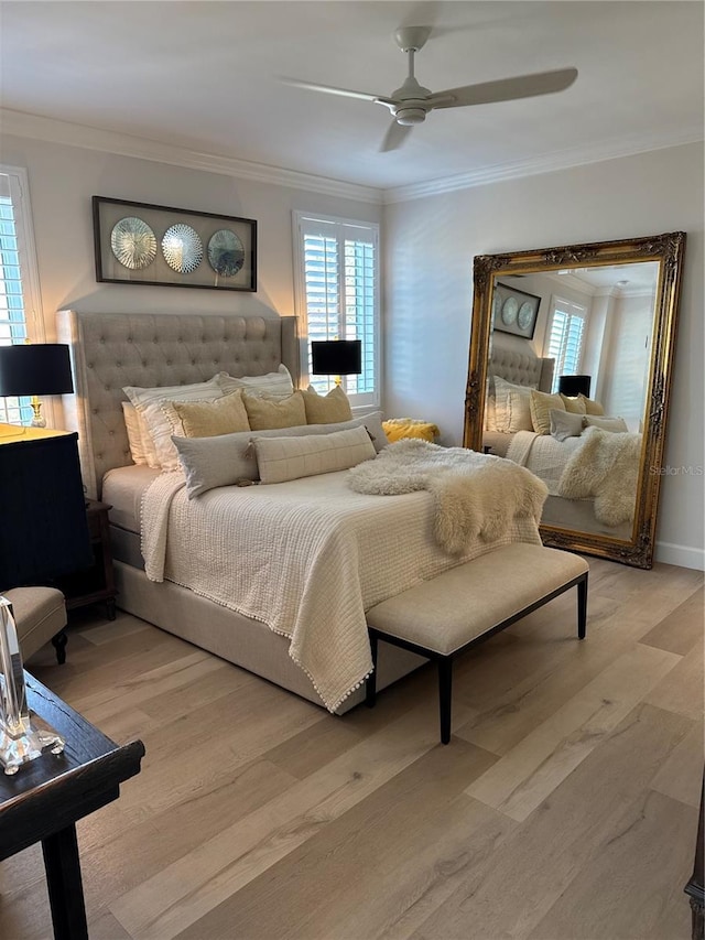 bedroom featuring ceiling fan, ornamental molding, and light hardwood / wood-style flooring