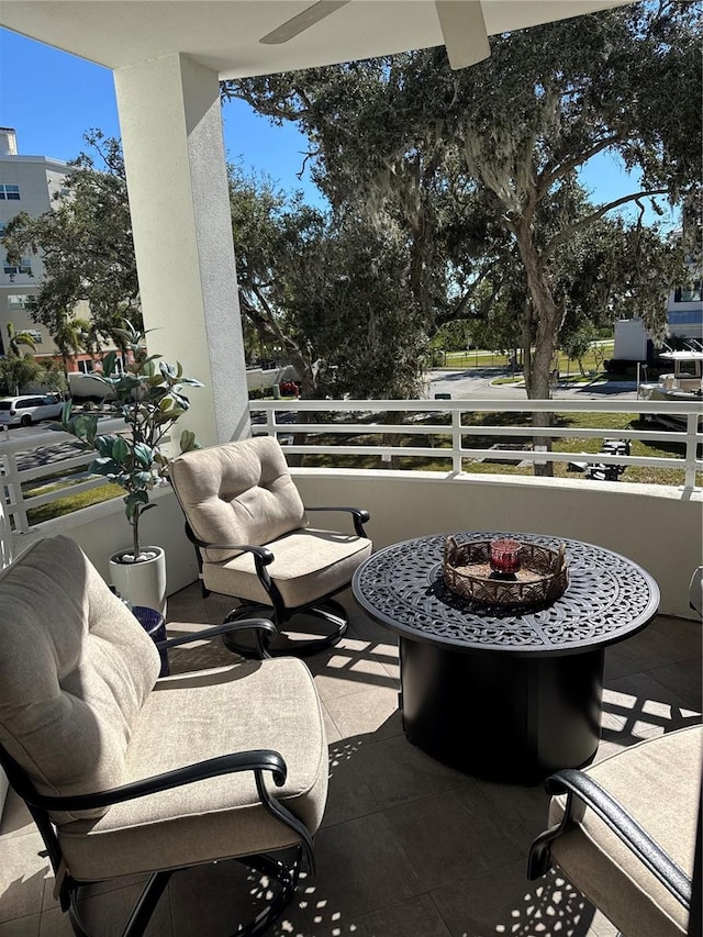 view of patio / terrace with a balcony and a fire pit