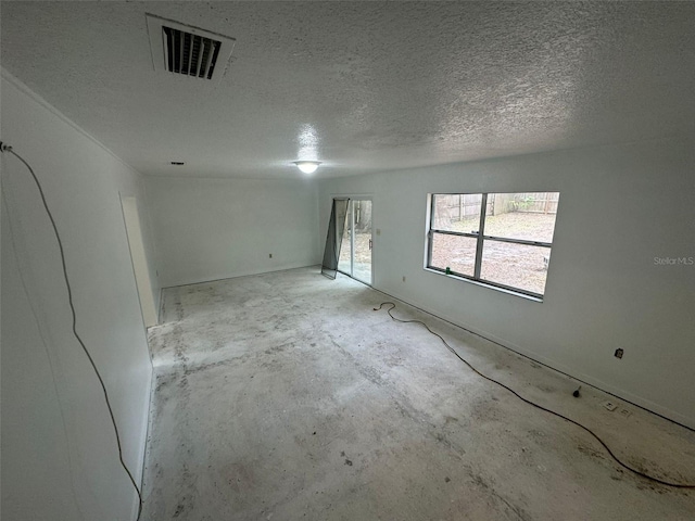 spare room with a textured ceiling