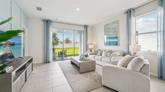 living room featuring light tile patterned floors and a wealth of natural light