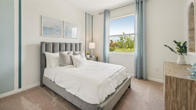 bedroom featuring carpet floors and multiple windows