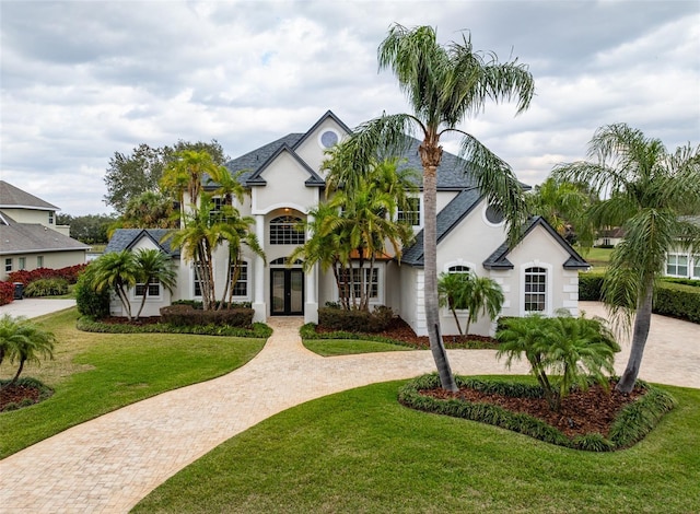 view of front of home with french doors and a front lawn