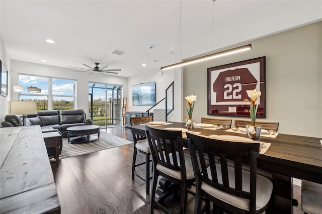 dining area with ceiling fan and dark wood-type flooring