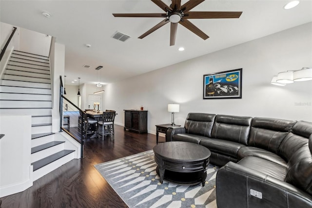 living room with dark hardwood / wood-style floors and ceiling fan