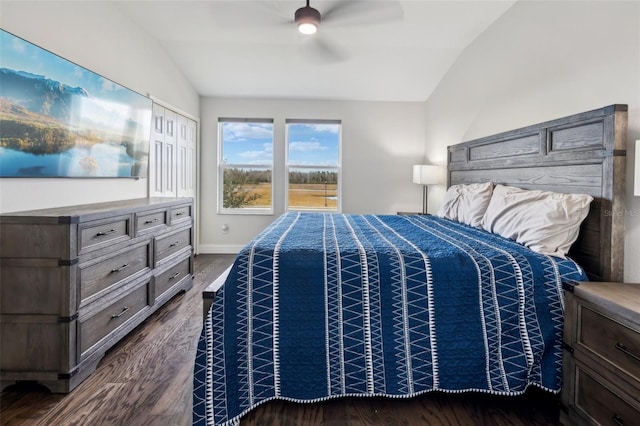 bedroom with ceiling fan, dark hardwood / wood-style floors, and lofted ceiling