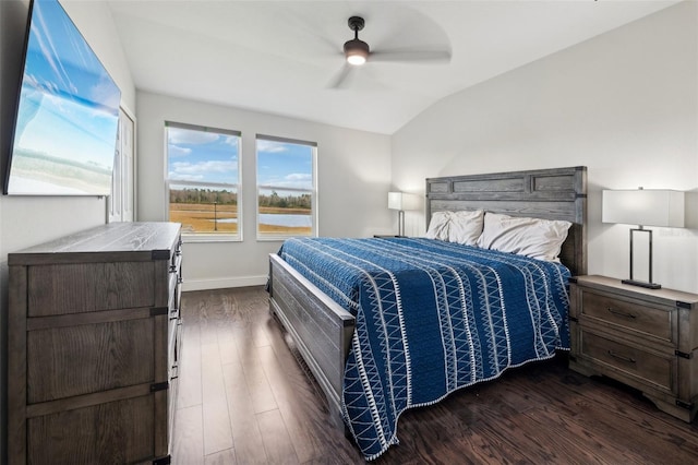 bedroom featuring dark hardwood / wood-style floors, vaulted ceiling, and ceiling fan