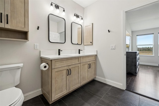 bathroom featuring vanity and toilet