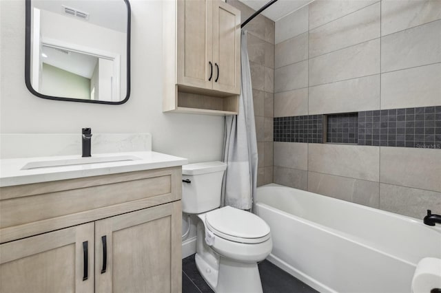 full bathroom with vanity, tiled shower / bath combo, and toilet