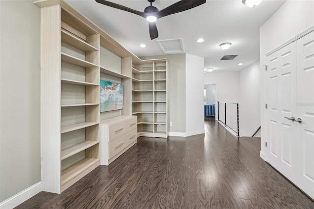 spacious closet with ceiling fan and dark wood-type flooring