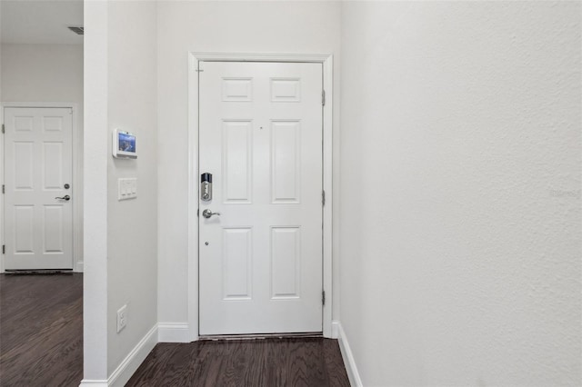 entryway with dark hardwood / wood-style floors