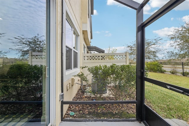 sunroom featuring a water view