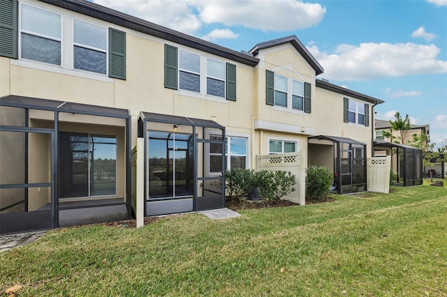 rear view of property featuring a lawn