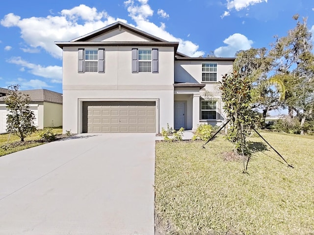 front of property featuring a front lawn and a garage