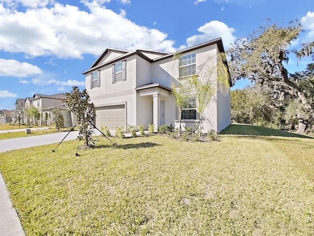 view of front facade with a garage and a front yard