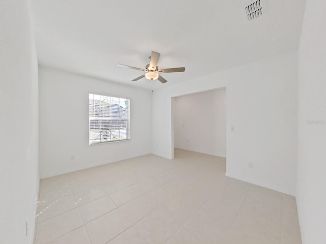 unfurnished room with ceiling fan and light tile patterned floors