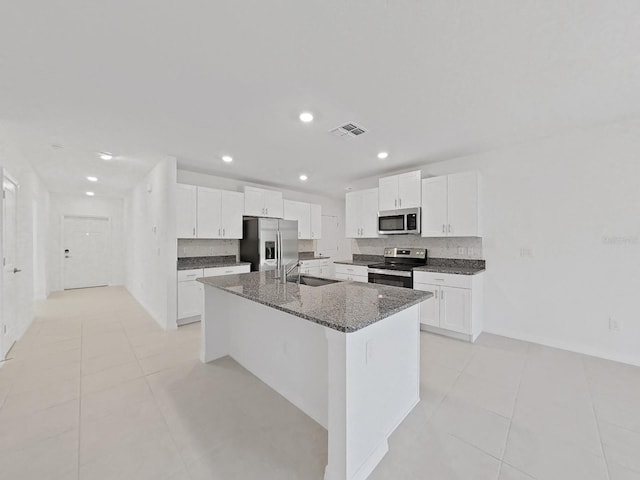 kitchen with sink, white cabinetry, a kitchen island with sink, and appliances with stainless steel finishes