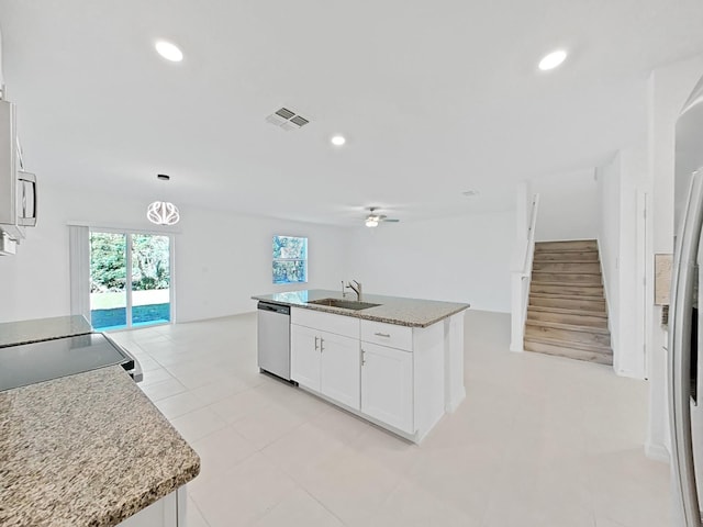 kitchen with stainless steel appliances, white cabinetry, sink, and a kitchen island with sink