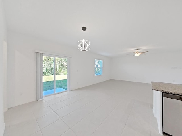 unfurnished living room with ceiling fan with notable chandelier and light tile patterned floors