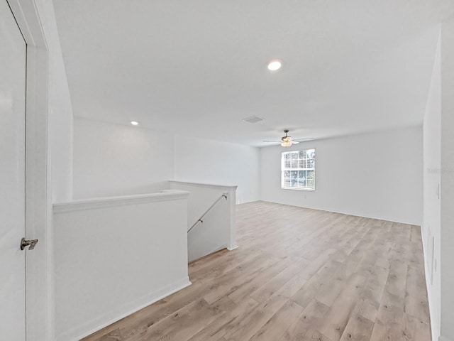 spare room featuring ceiling fan and light hardwood / wood-style flooring