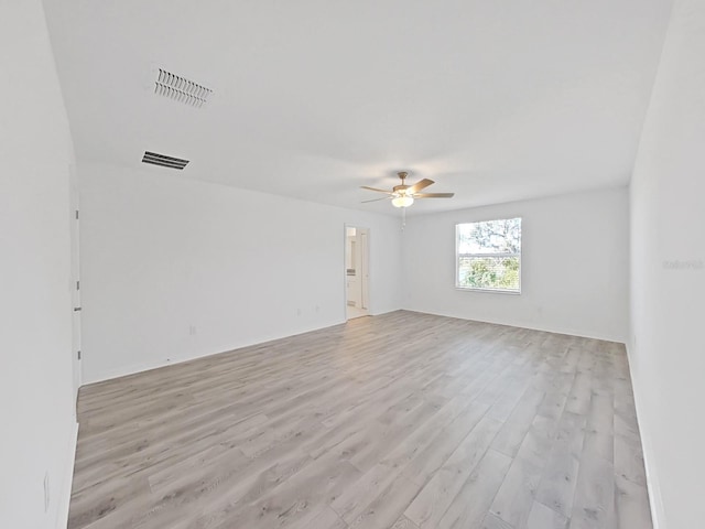 spare room with light hardwood / wood-style floors and ceiling fan