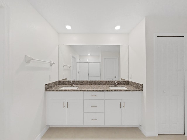 bathroom with an enclosed shower and vanity